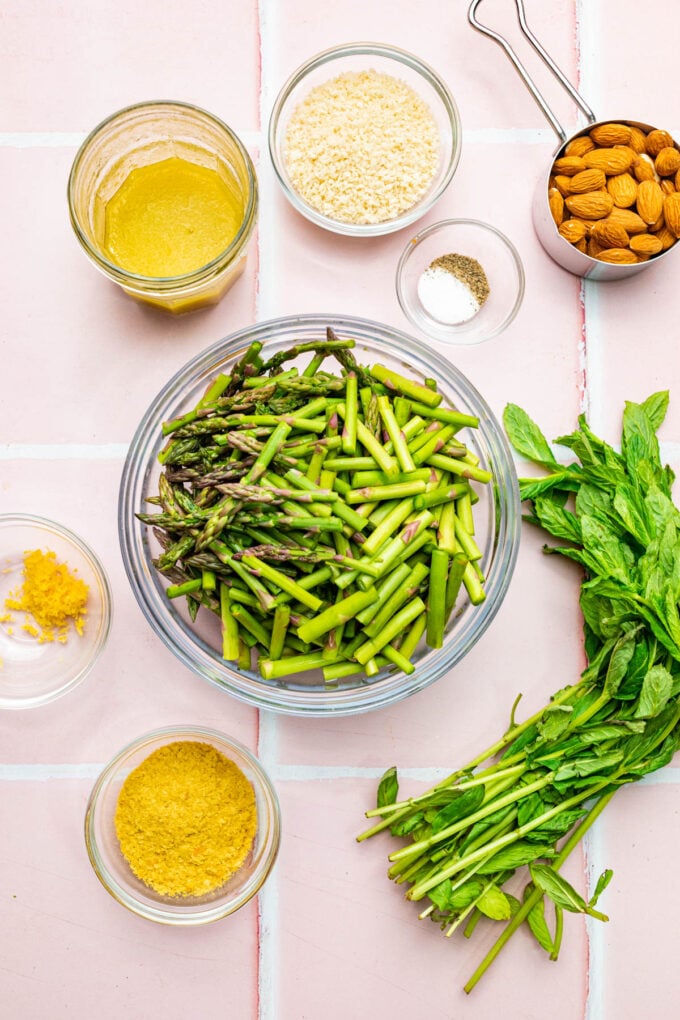 cold asparagus salad ingredients in bowls