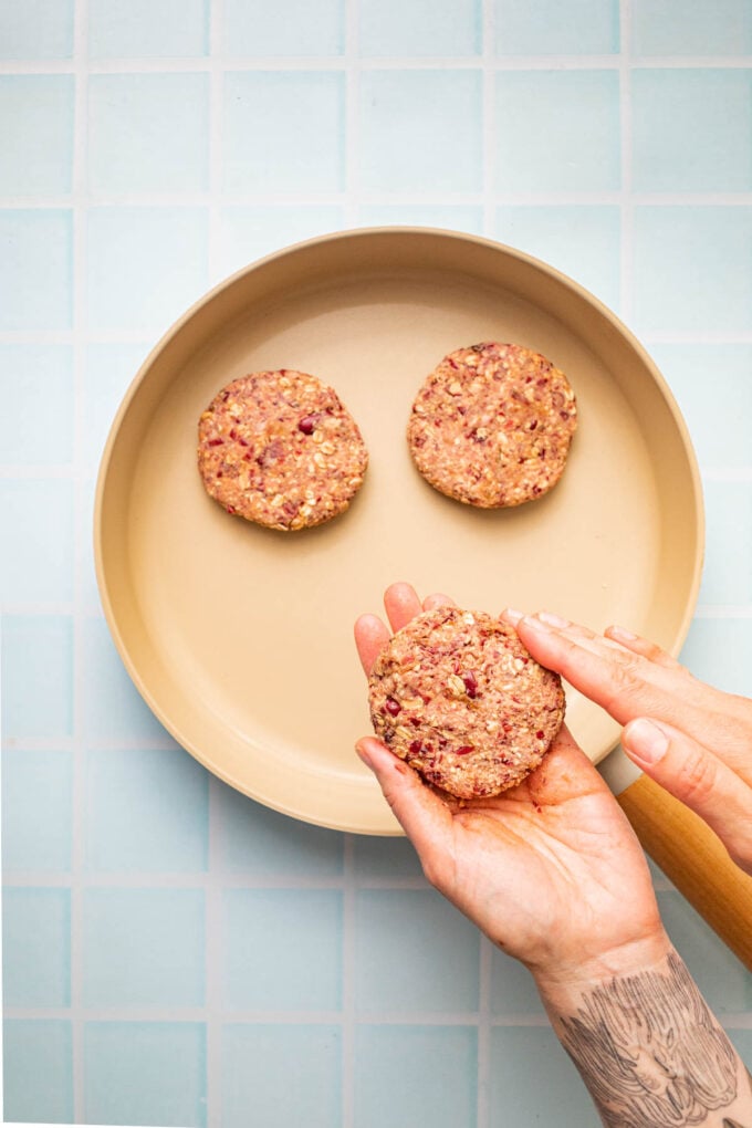 hand with veggie burger patty