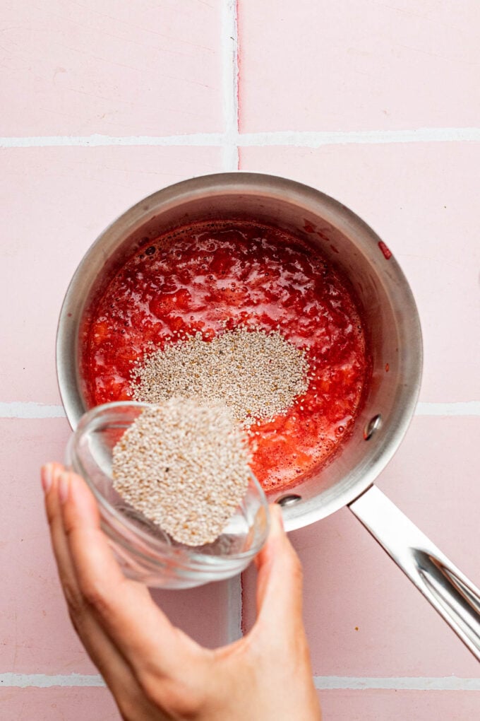 hand adding chia seeds to pot