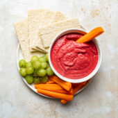 beet dip in bowl with carrots