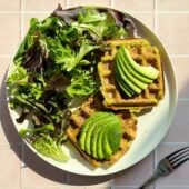 waffles with avocado and salad on plate