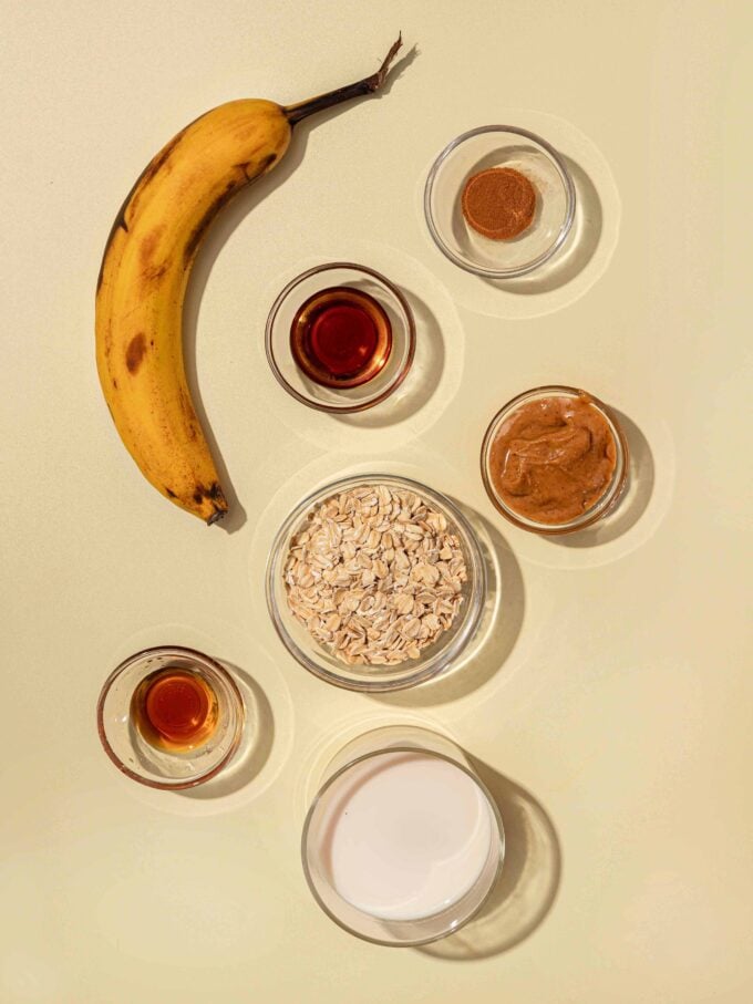 banana, oats and milk in bowls