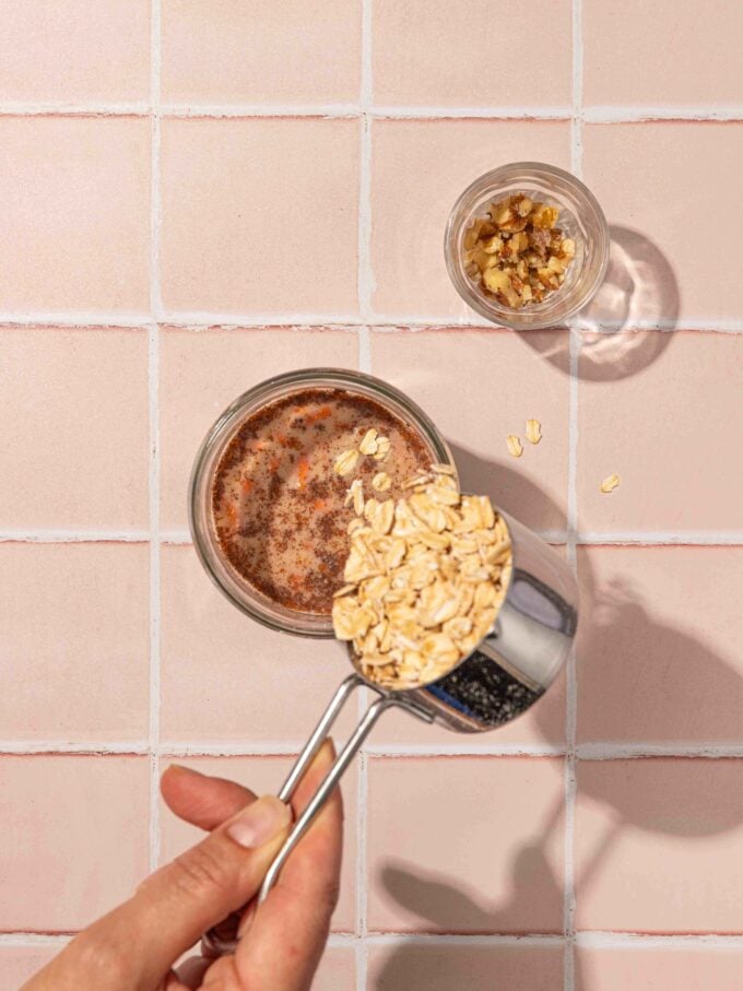 hand pouring oats into jar