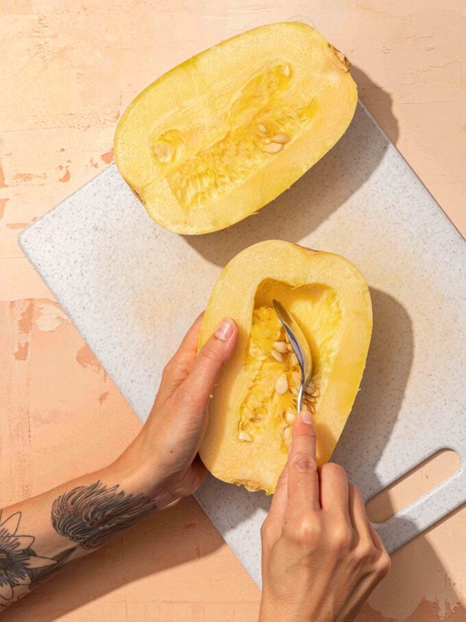 hand scooping spaghetti squash