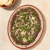 black bean dip on plate with crackers in bowl