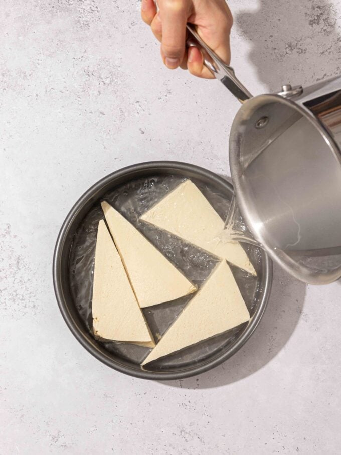 pouring water over tofu