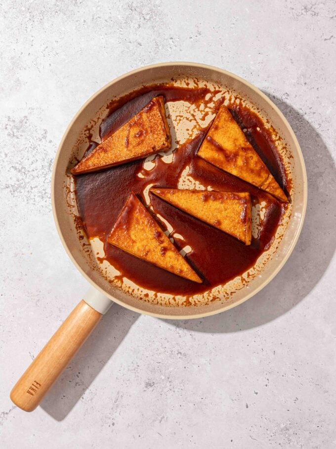 brown sugar glazed tofu steaks in beige skillet