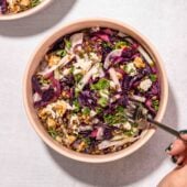 roasted red cabbage salad in pink bowl with fork