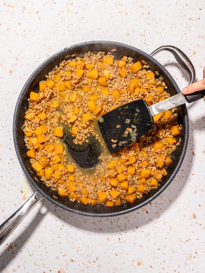 spatula stirring vegan farro risotto