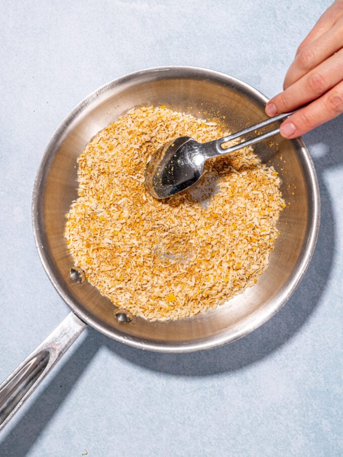 spoon and bread crumbs in skillet