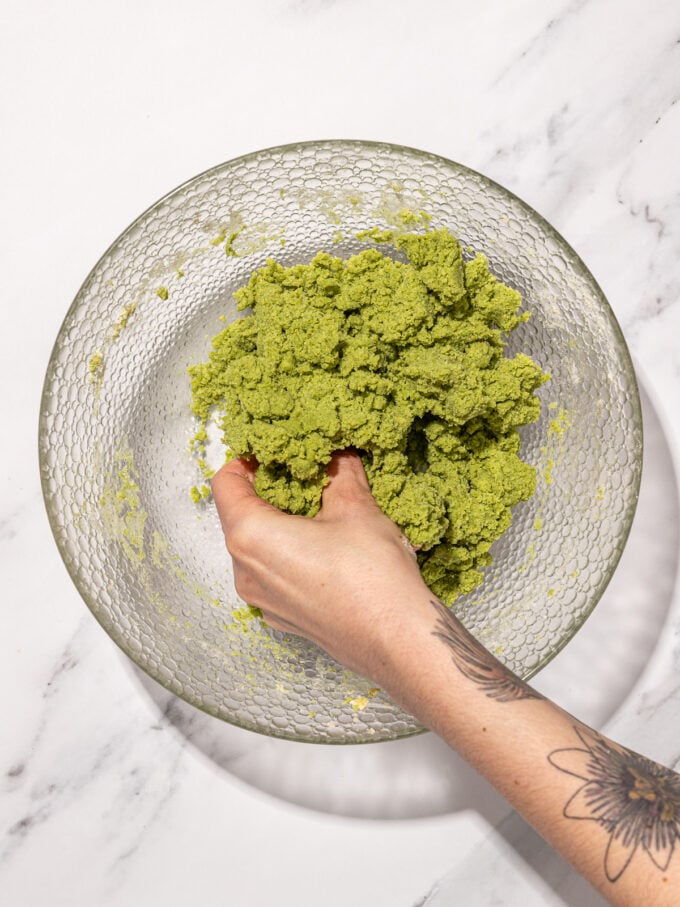 hand kneading matcha cookie dough