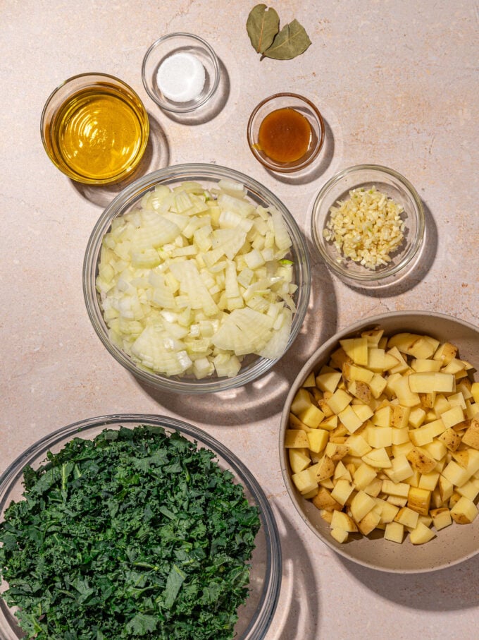 onions, potato and kale in bowls