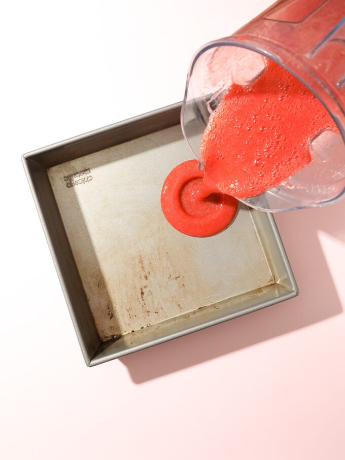 pouring strawberry juice into a pan