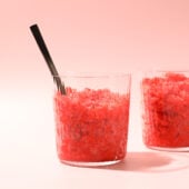 strawberry granita in glass with black spoon