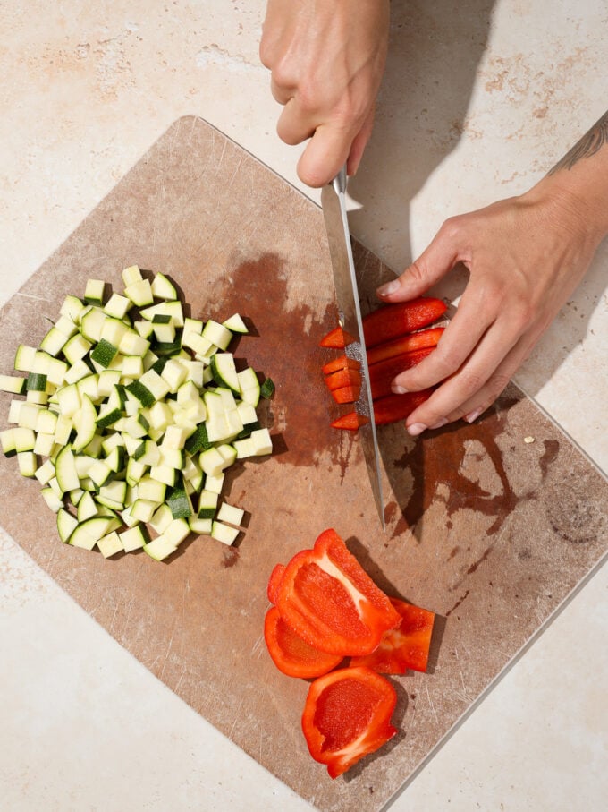 Hand chopping red pepper with knife