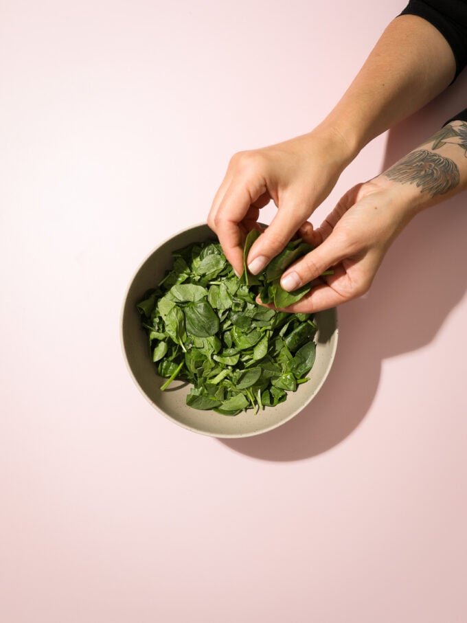 Hand tearing spinach