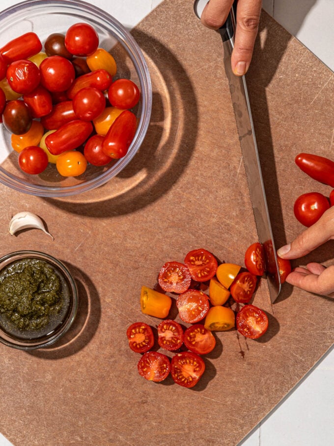 hand slicing tomatoes