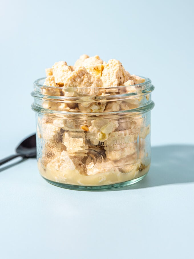 crumbled tofu feta in glass jar with black spoon