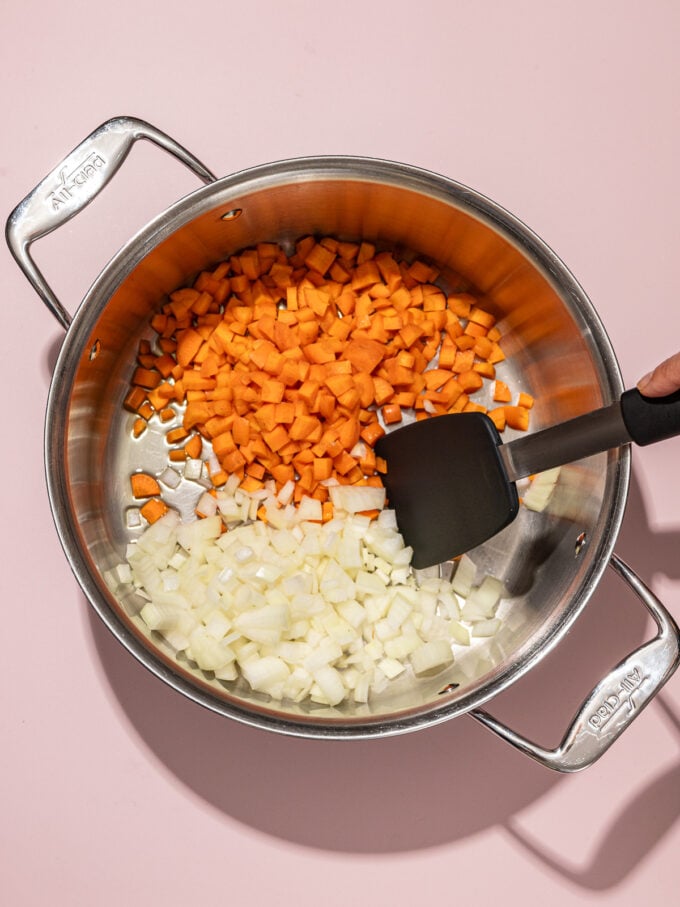 spatula stirring onion and carrot